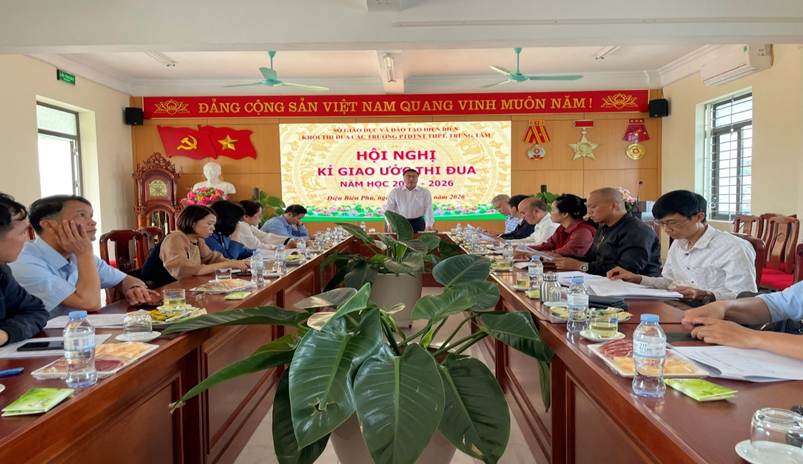 '''A group of people sitting at long tables
Description automatically generated'''