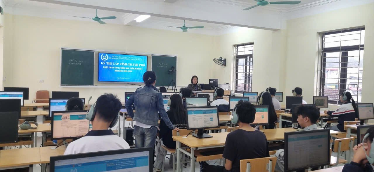 ''A group of people in a room with computers

Description automatically generated''