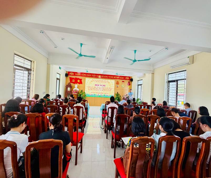 '''A group of people sitting in chairs in a room

Description automatically generated'''