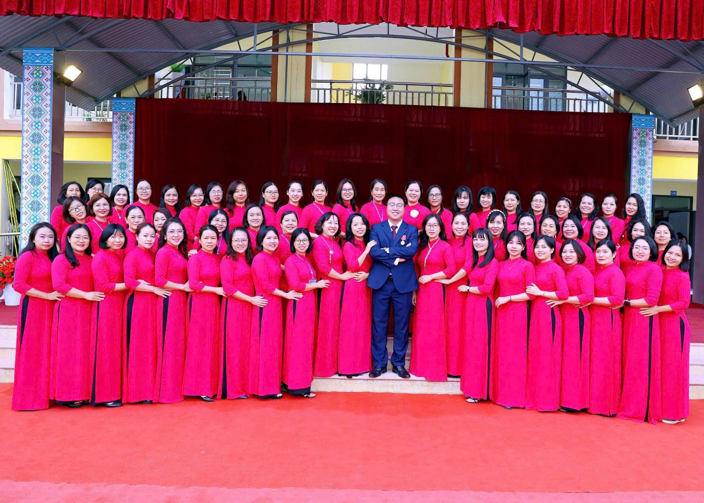 'A group of people in red dresses

Description automatically generated'