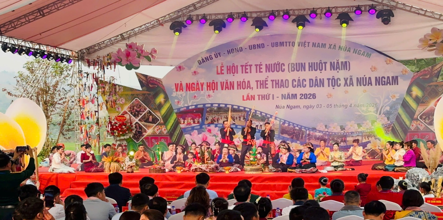 '''A group of people sitting in front of a stage
Description automatically generated'''