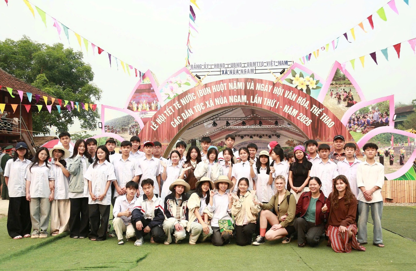 '''A group of people posing for a photo
Description automatically generated'''