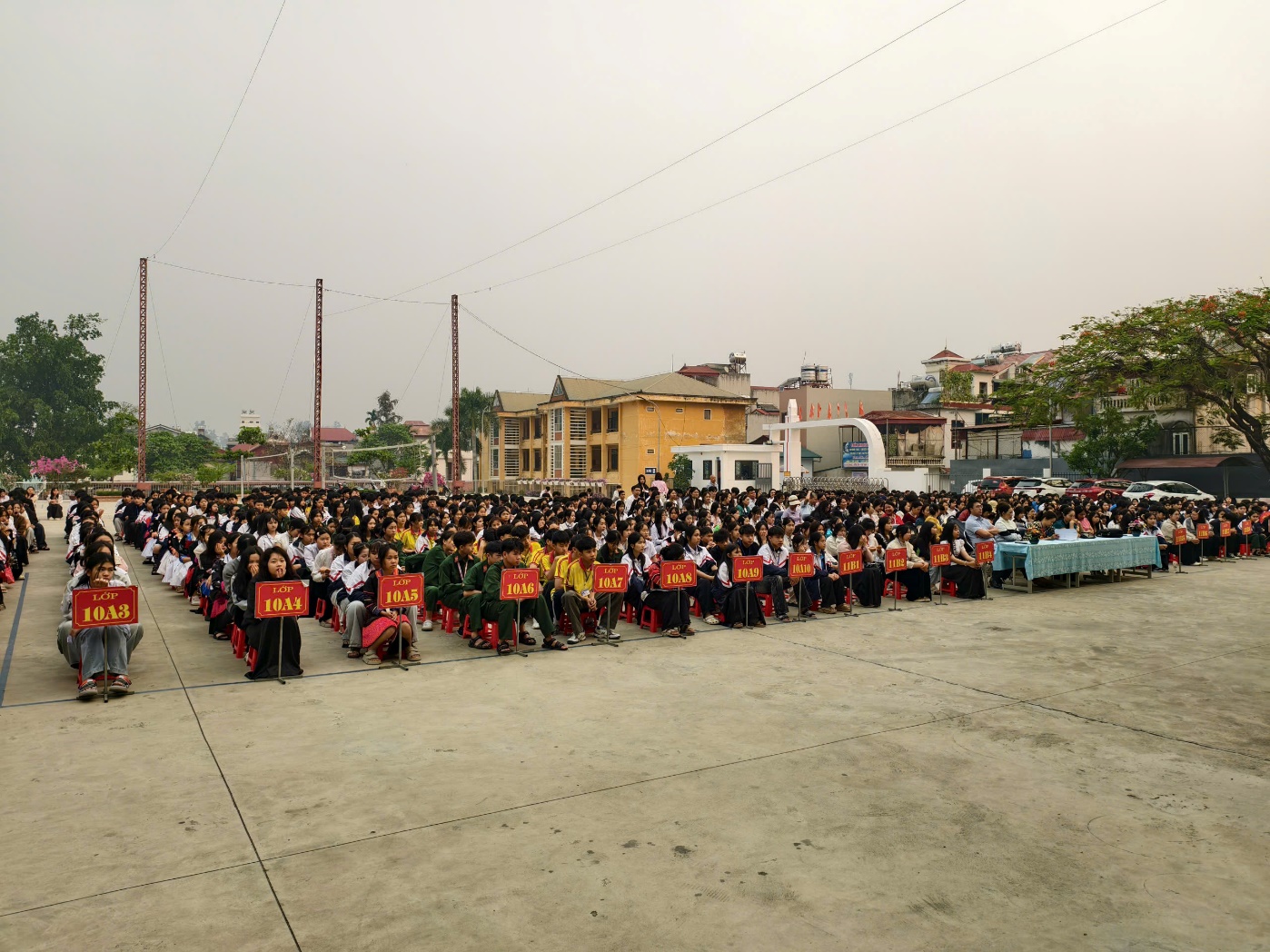 'A group of people sitting in a row
Description automatically generated'