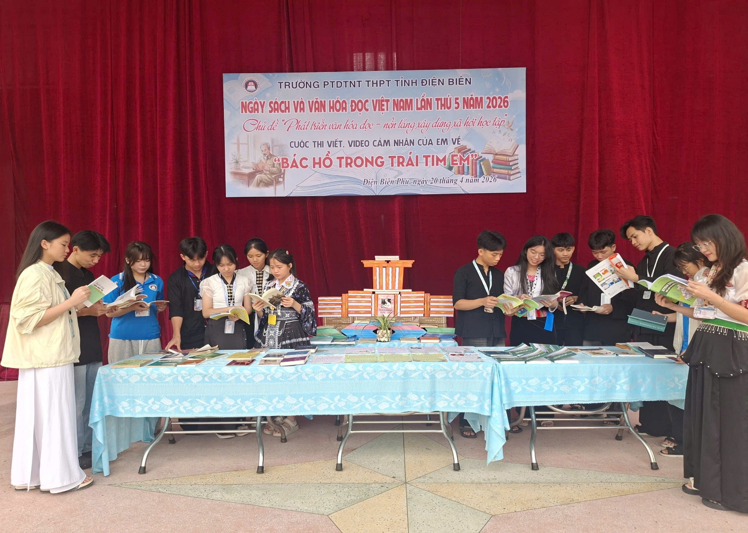 'A group of people standing around a table

Description automatically generated'