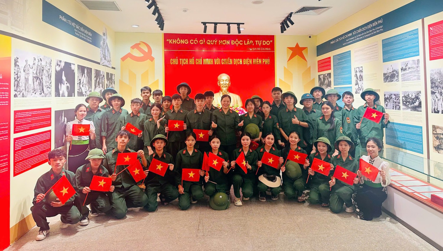 ''A group of people in uniform holding flags

Description automatically generated''